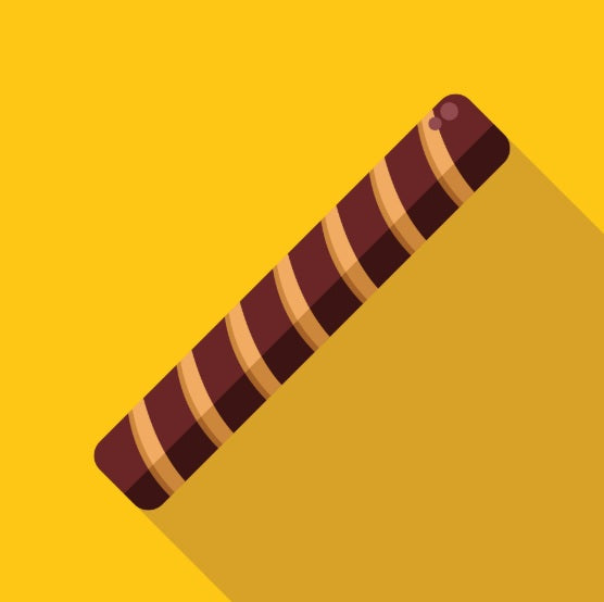 chocolate wafer stick with caramel spiral design on yellow background