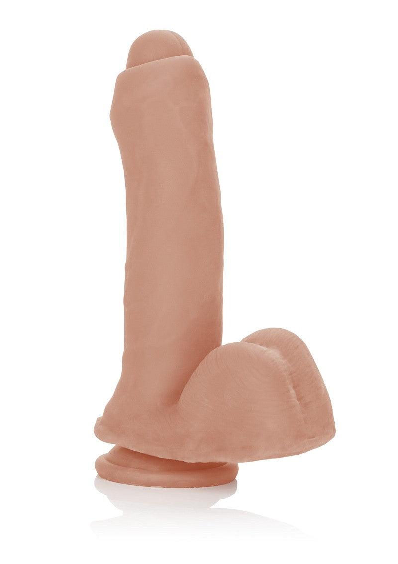 Realistic flesh-tone dildo with testicles and suction base on white background