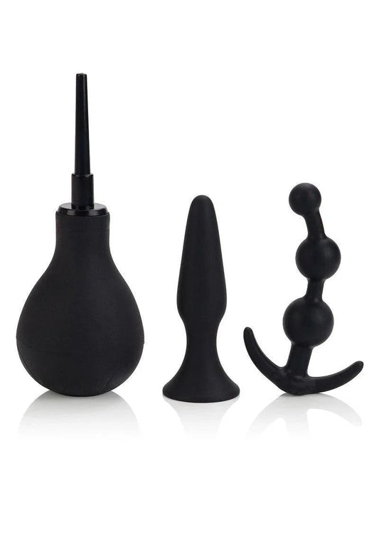 Black anal hygiene and pleasure kit including enema bulb, smooth butt plug, and beaded anal plug on white background