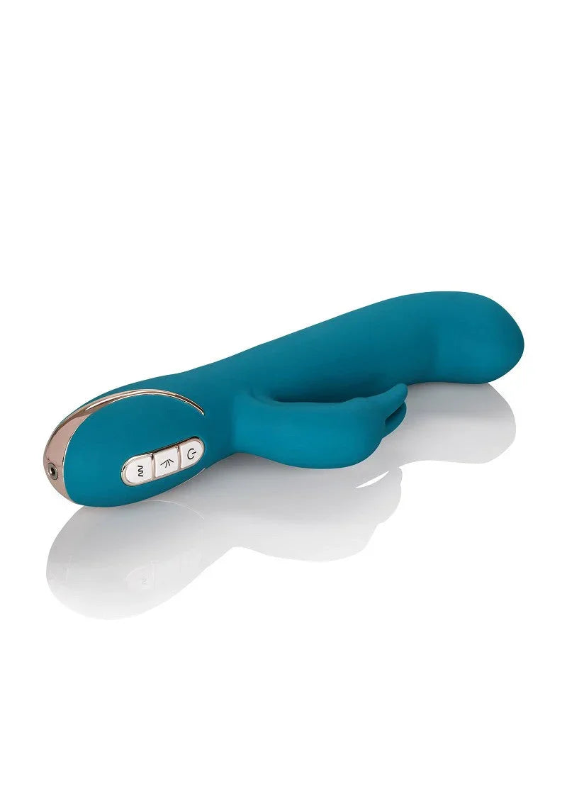 Teal silicone rabbit vibrator with dual motors and control buttons on a white reflective surface