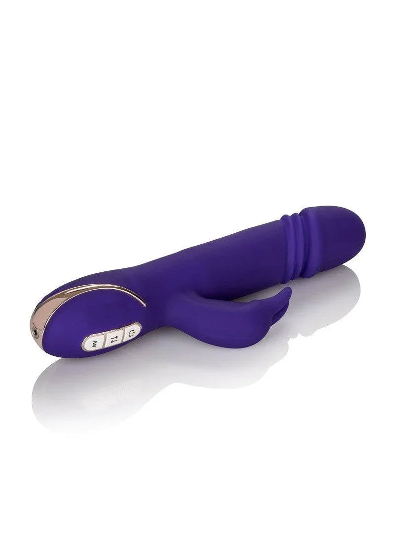 Purple silicone rabbit vibrator with dual stimulation and control buttons on reflective white surface