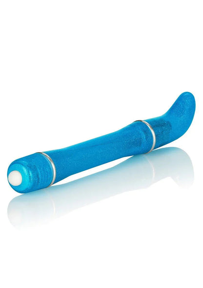 Blue glittery mini G-spot vibrator with curved tip and white button on reflective white surface