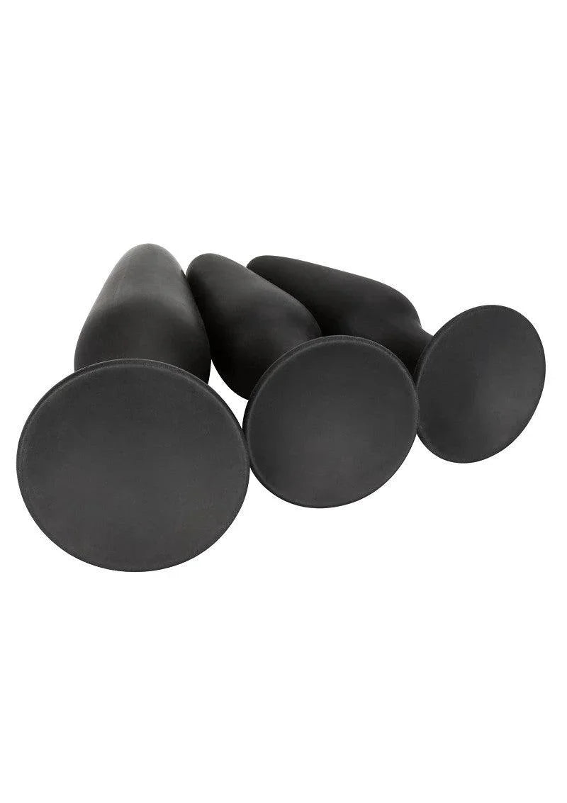 Set of three black silicone anal trainers with wide flared bases on white background