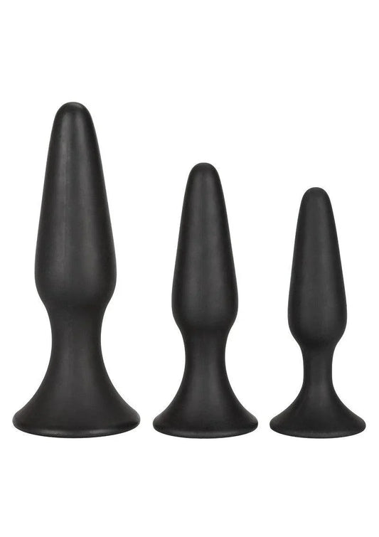 Set of three black silicone anal trainer plugs in varying sizes with flared bases on white background