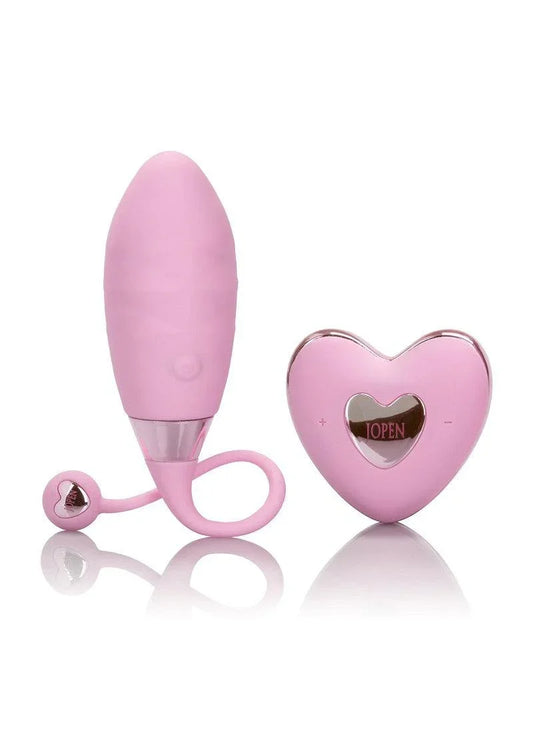 Pink remote-controlled sex toy with heart-shaped wireless controller on white background
