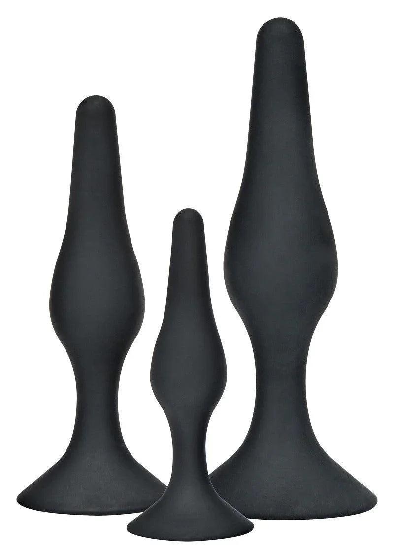 Three black silicone anal plugs of varying sizes with flared bases on white background