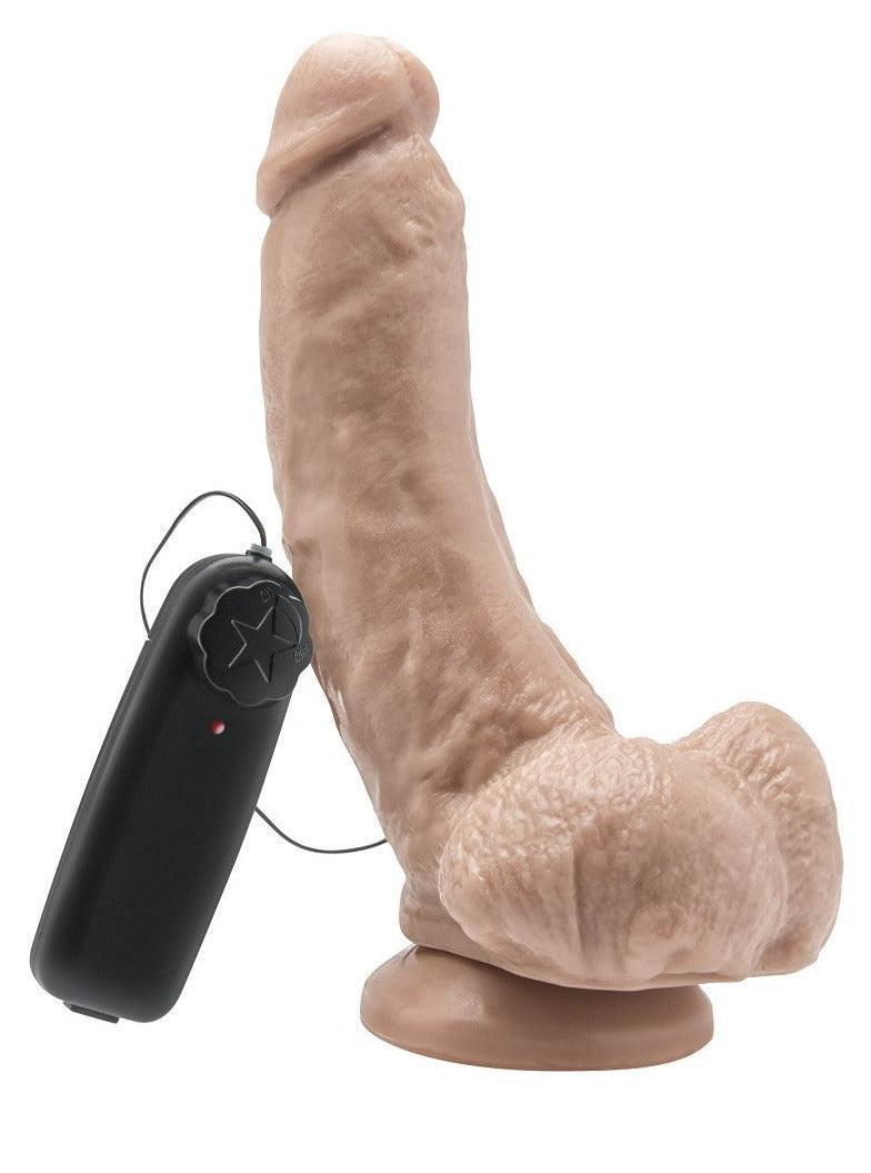 Realistic dildo vibrator with remote control in flesh tone on white background